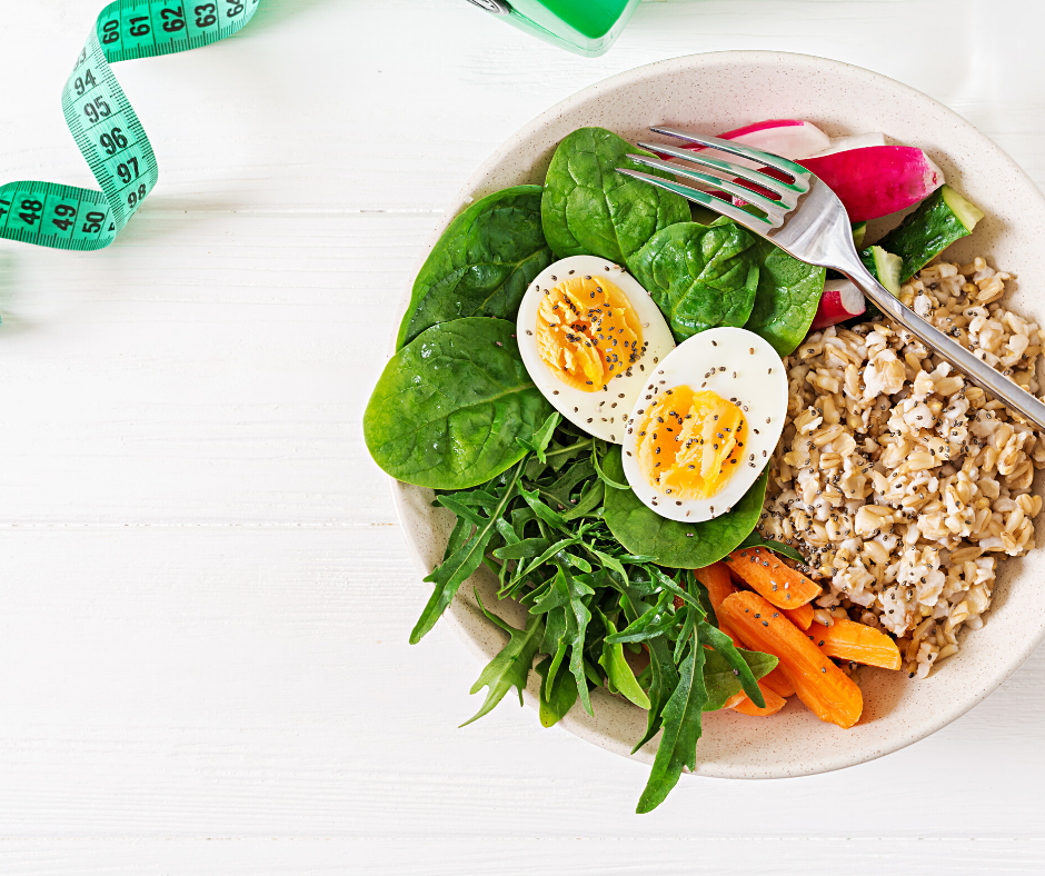 Bowl with greens, hard boiled egg, grains, and vegetables