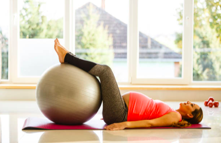 pregnant woman stretching with an exercise ball